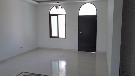 Spacious bright living room with tile floors and arched windows in Hacienda Pacífica home San Carlos Panama