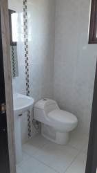 Compact modern bathroom white tiles mosaic stripe in house Hacienda Pacífica San Carlos Panama