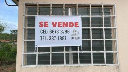 Beige facade with metal bars on window and for sale sign Costa Verde Panama