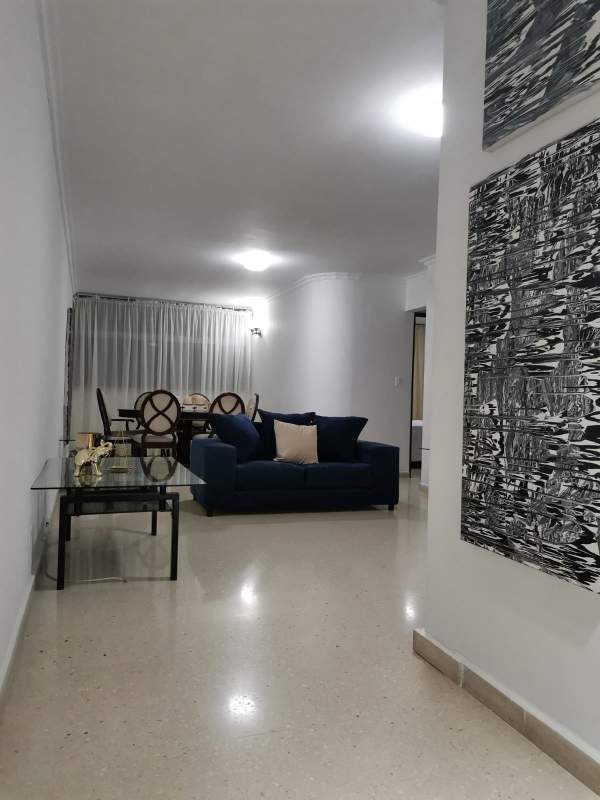 Modern apartment living with navy sofas, dining area, marble flooring in PH BICSA Financial Center Panama City