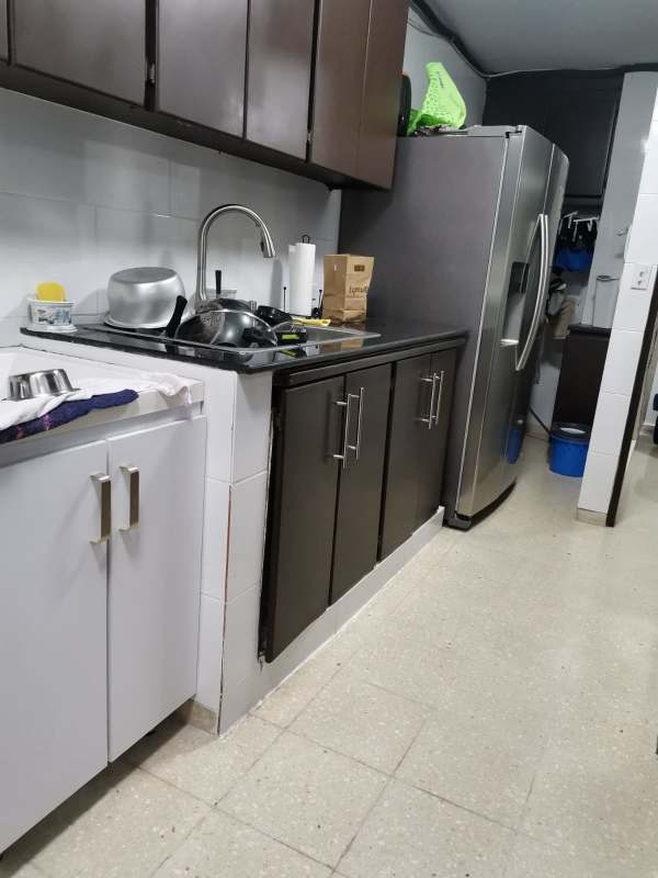 Modern kitchen with black granite countertops, stainless fridge at PH BICSA Financial Center Panama City
