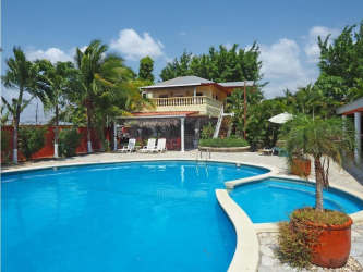 Large tropical backyard with swimming pool surrounded by palm trees in Nueva Gorgona Panama