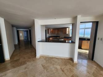 Modern kitchen with island granite countertops, wood cabinets, ocean views in The Alcazar Penthouse Coronado Panama
