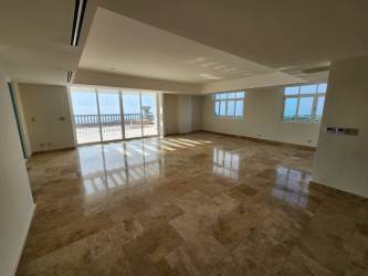 Spacious living room featuring marble floors, large windows with ocean views in The Alcazar penthouse Coronado Panama