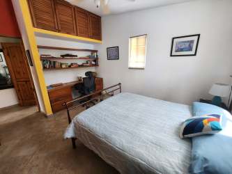 Bathroom with stone tile accents, shower, and vanity in Gorgona beach home