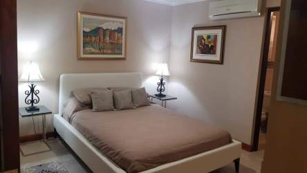 Spacious master bedroom with ocean-facing balcony at Coronado Country Club