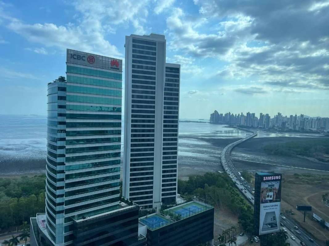Aerial view skyscrapers coastline Costa del Este with bridge Panama City