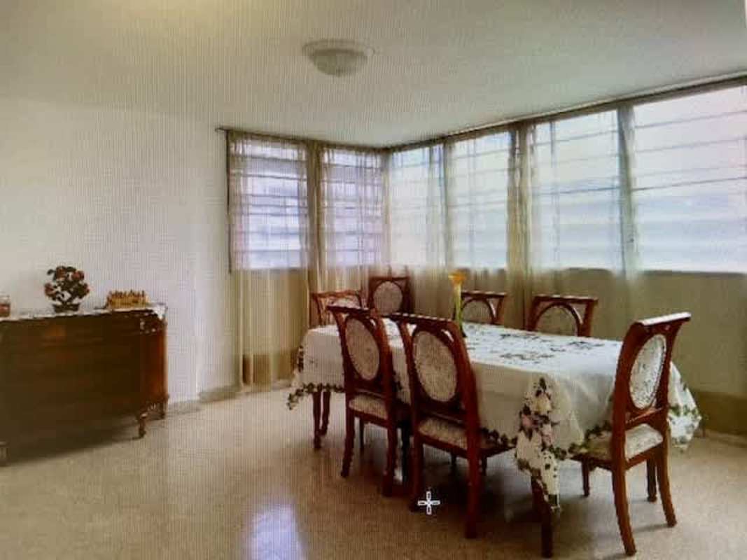 Formal dining area with large corner windows PH Tiquiyoli Panama City apartment