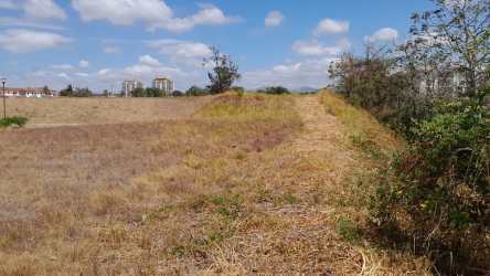 Open 1,205m2 lot ready for development in Vista Mar Resort San Carlos with tropical landscape