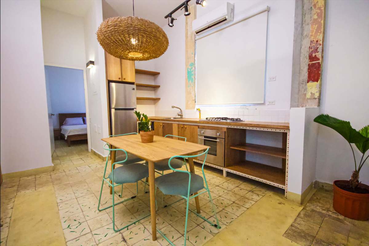 Minimalist rustic kitchen with wood accents and dining area Casco Viejo Panama