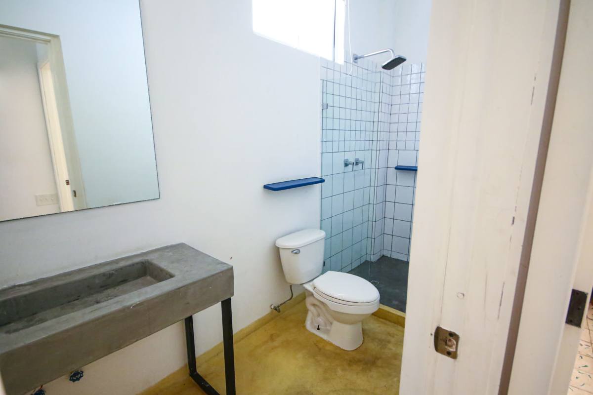 Open kitchen with rustic design, wood cabinetry, oven in Casco Viejo rental Panama