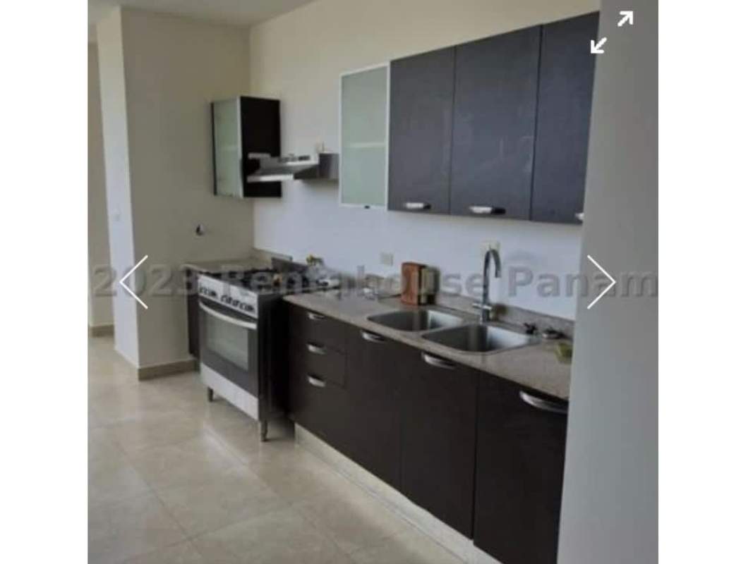 Sleek kitchen with granite countertops, dark cabinetry, gas stove in Pearl at the Sea Costa del Este Panama