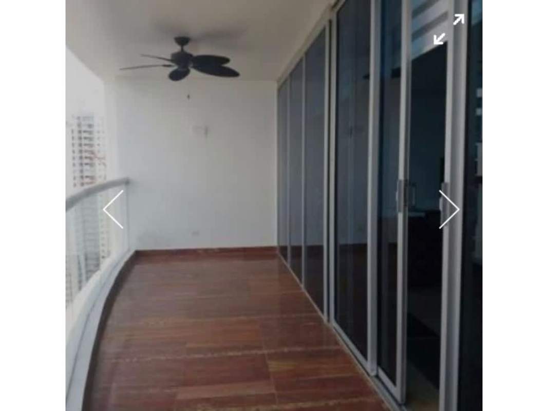 Large terrace balcony with ceiling fan and panoramic city ocean views at Costa del Este