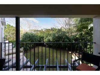 Spacious bedroom with window overlooking greenery at Puerta del Sol Buenaventura Panama