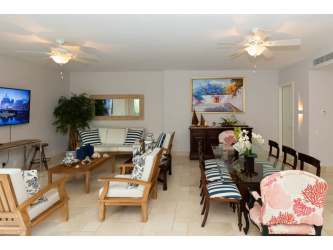 Bright bedroom with sliding glass door to balcony overlooking gardens in Buenaventura Panama