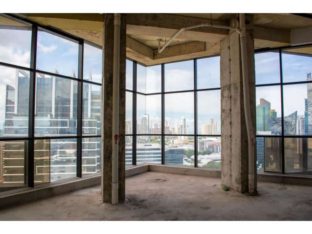 Unfinished high rise office with panoramic windows overlooking Panama City skyline