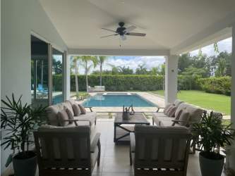 Open-plan living and dining room in luxury Bijao villa Panama with garden view, modern design