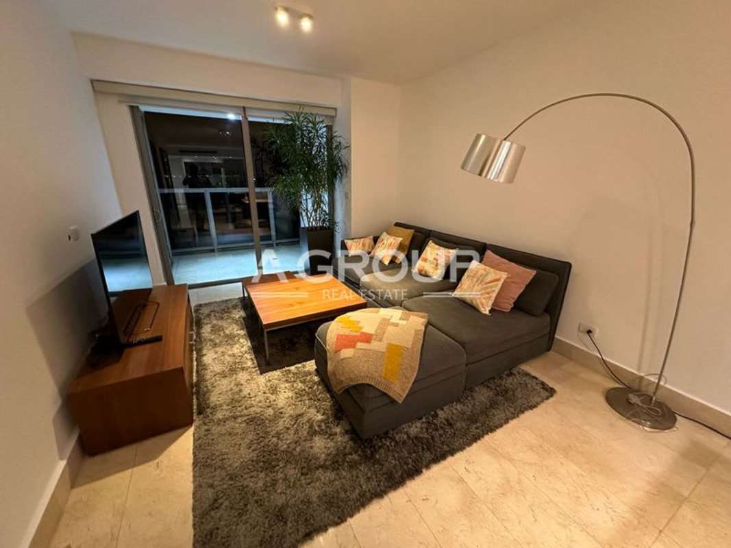 Modern dining space with open kitchen in Yoo Panama apartment