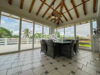 Bright dining and living room with tall wooden ceilings, natural light in Coronado beach house Panama for rent