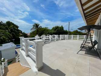 Private tropical swimming pool at beach rental house in Coronado Panama with palm landscaping