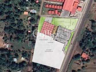 Aerial image showing layout of commercial plaza with parking and green areas in Capira Panama