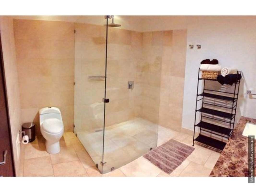 Elegant bathroom with rainfall glass shower and marble vanity at PH The Ocean Club