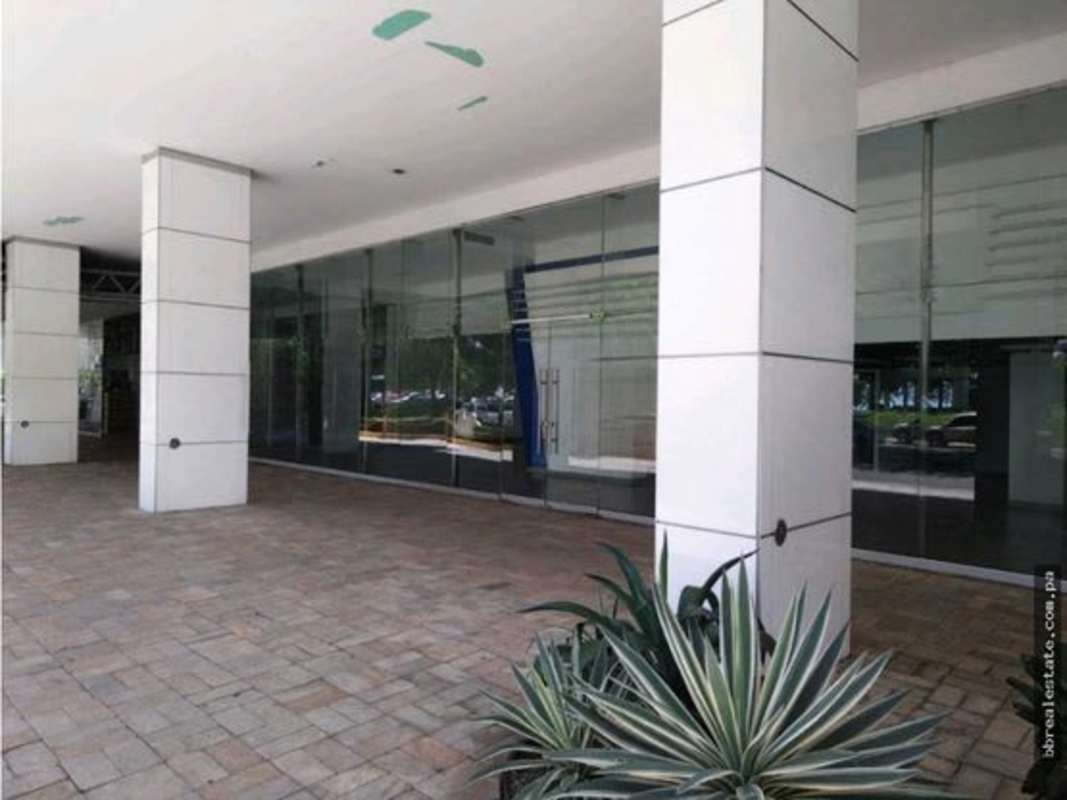 Modern glass storefront facade with columns along Avenida Balboa in PH BICSA Tower Panama