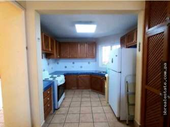 Kitchen with blue tile countertops, wood cabinets, and tiled floor in Coronado Panama beach villa rental