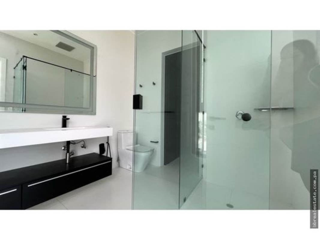 Spacious modern kitchen with quartz countertops, island, stainless appliances in PH Ocean Reef Panama City