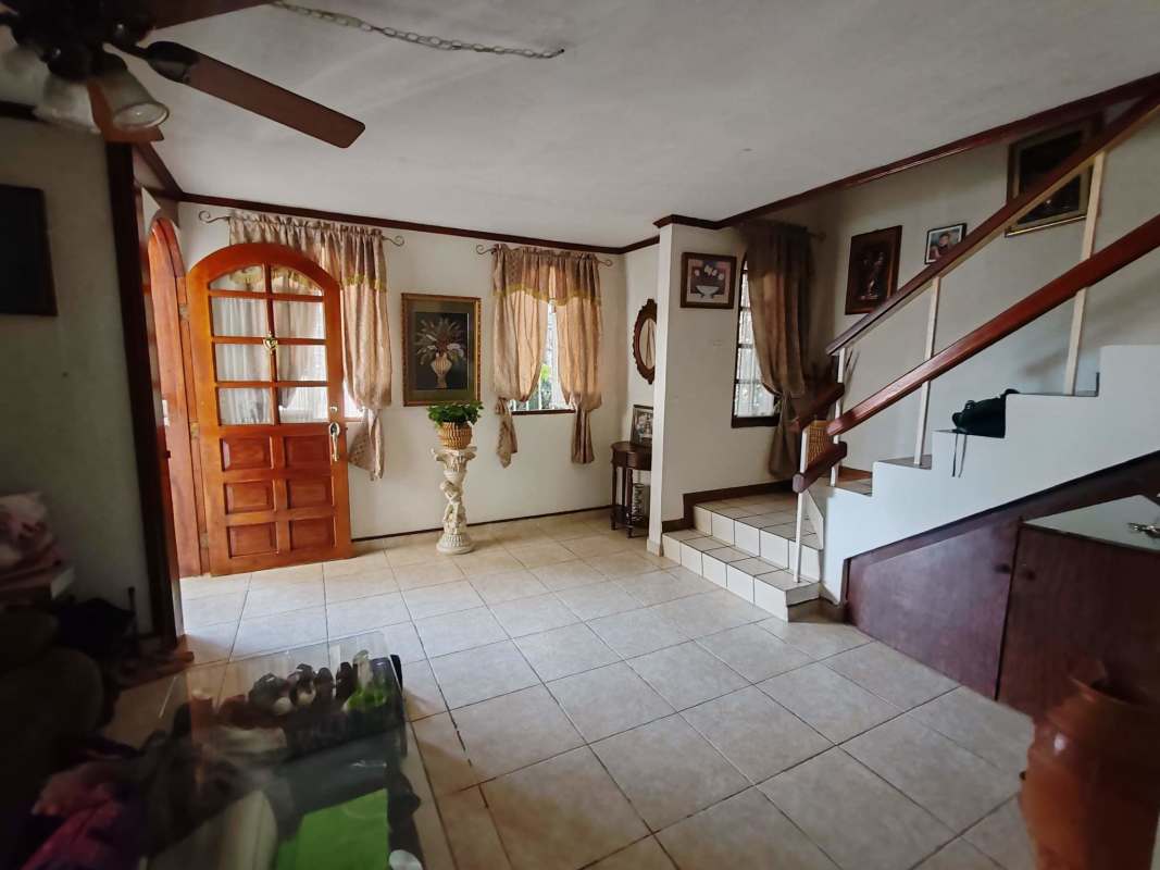 Stairwell with tile and wood railings decorative wall art in family house Altos de Panama