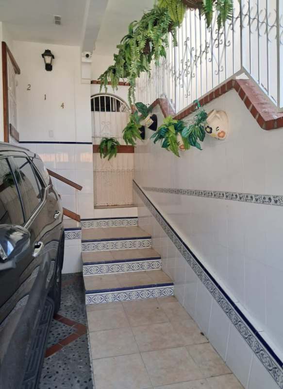 Living room with ceiling fans, large window and open layout in Condado del Rey home