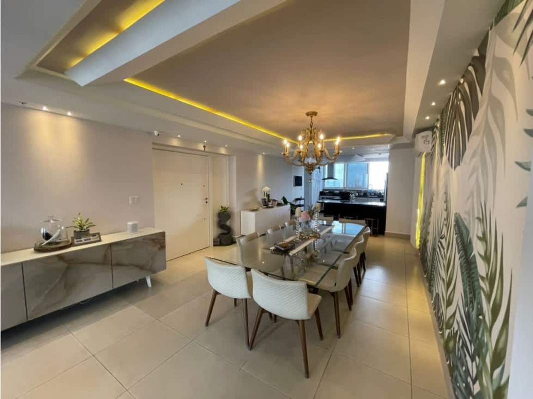 Luxury penthouse dining with tropical accent wall, lighting and open plan kitchen PH Park City Obarrio Panama