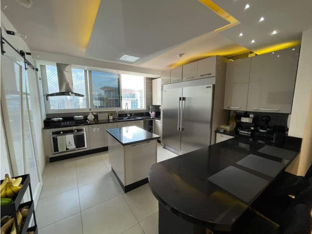 Open kitchen with island, stainless steel appliances, large windows penthouse PH Park City Obarrio Panama