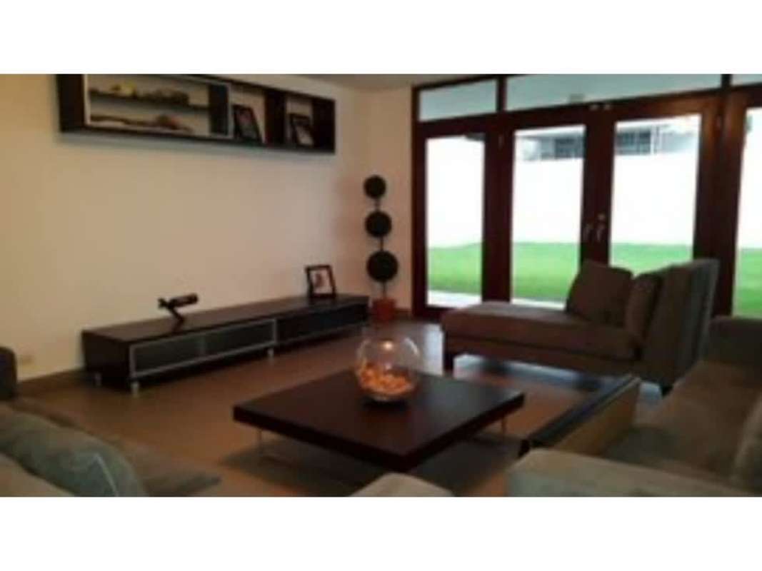 Contemporary kitchen with wood cabinets and granite counters in duplex Obarrio Panama