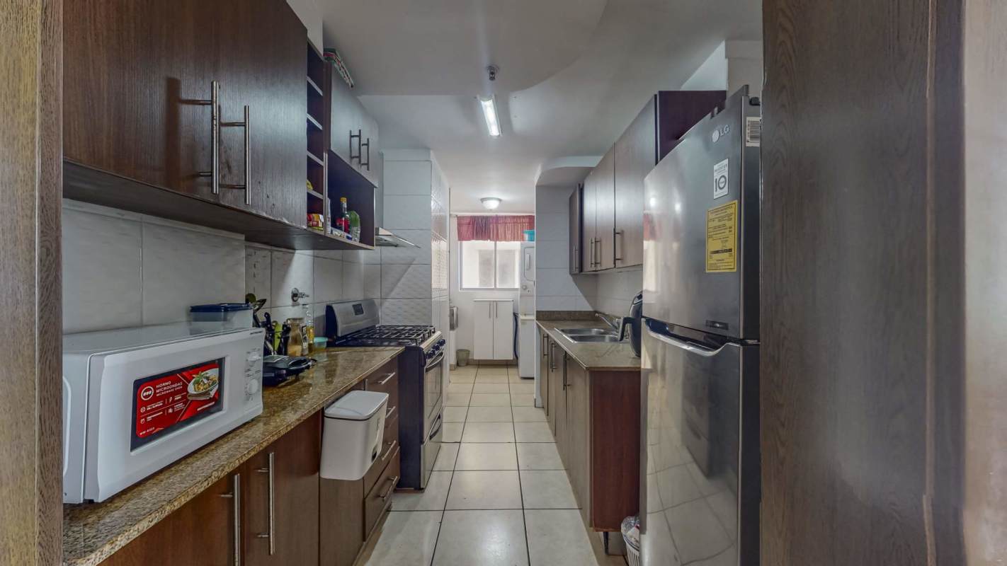 Kitchen with laundry appliances space and granite countertop Victoria Hills Panama
