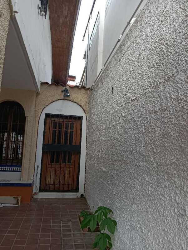 Gated balcony with iron bars, wood ceiling and hanging chandelier at Villa Soberanía house Panama