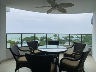 Bright living and dining room with large windows ocean views at Playa Blanca Resort