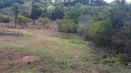 Mountain backdrop behind large flat vacant lot at Volcán entrance, Chiriquí Panama