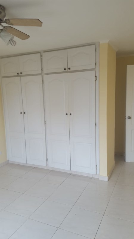 Living-dining room with tile floors, balcony view, ceiling fan in Panama City Condado del Rey apartment