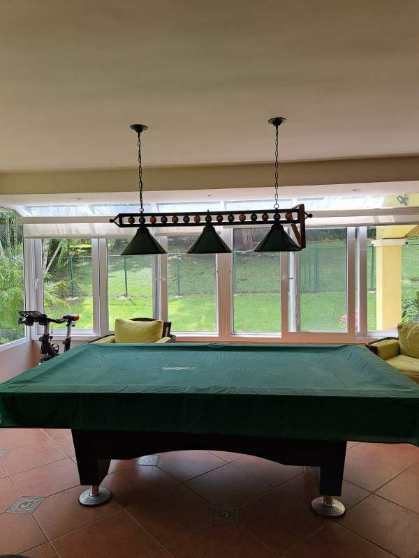 Large open-plan living dining room with chandelier, tray ceilings in Cardenas Village Clayton Panama