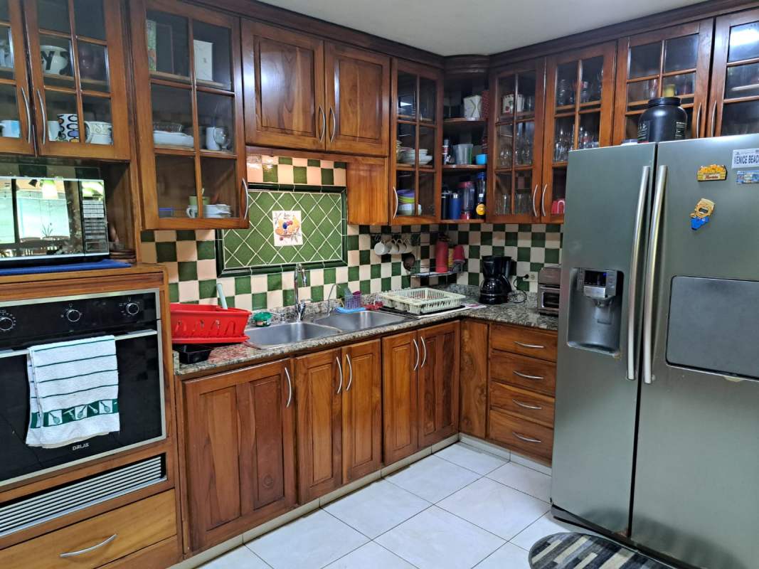 Furnished bedroom with blue bedding, ceiling fan, AC, tiled floor in Cardenas Village Clayton Panama