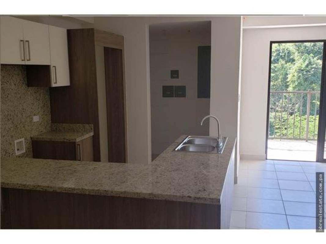 Modern kitchen with granite countertops, double sink, cabinetry, and balcony access PH Embassy Village Clayton Panama