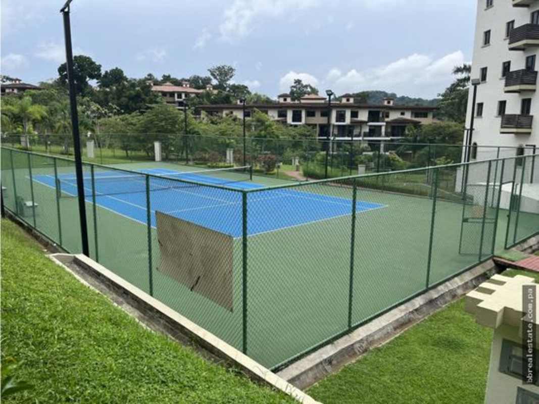 Modern apartment complex exterior with swimming pool, loungers and tropical landscaping PH Embassy Village Clayton Panama