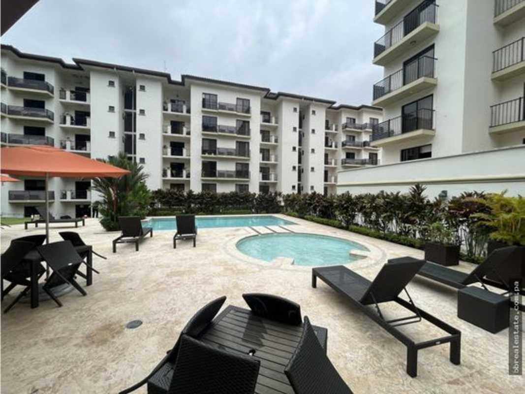 Courtyard view with swimming pool, sun loungers and tropical landscaping PH Embassy Village Clayton Panama