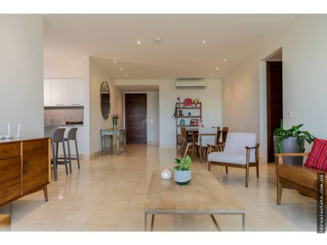 Open-plan living dining with neutral colors and golf course views in PH Greenview Panama