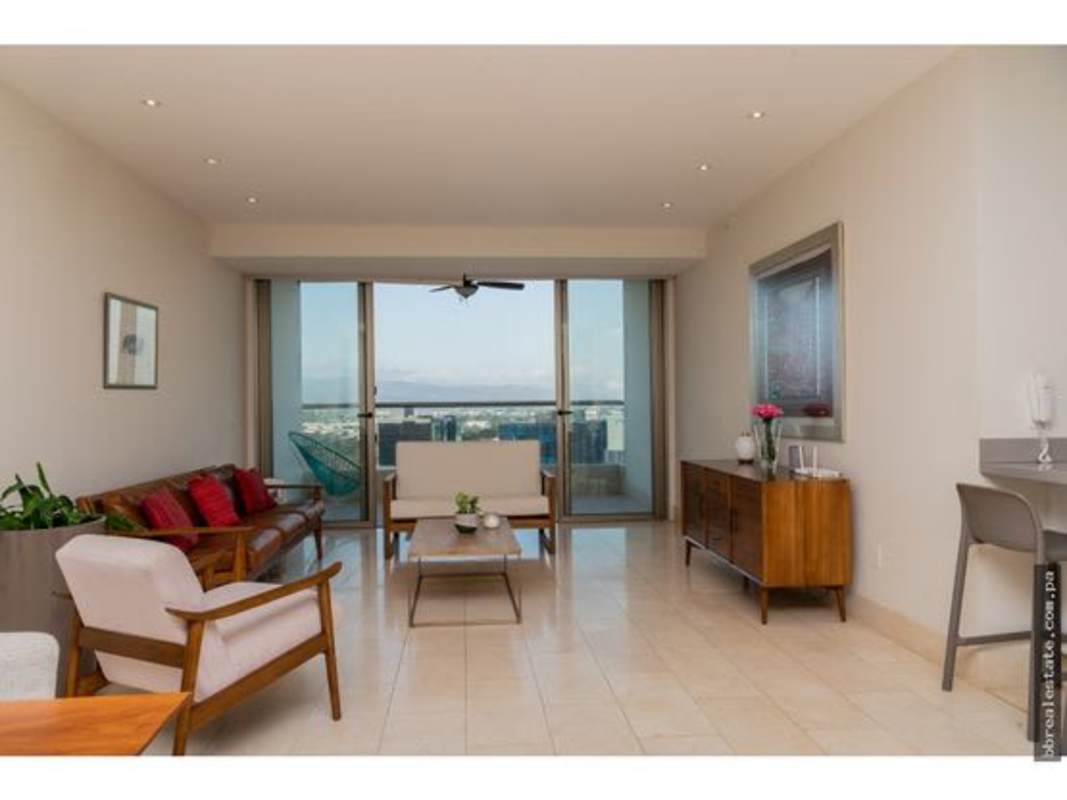 Modern living room opening onto balcony, city skyline views, PH Greenview Panama
