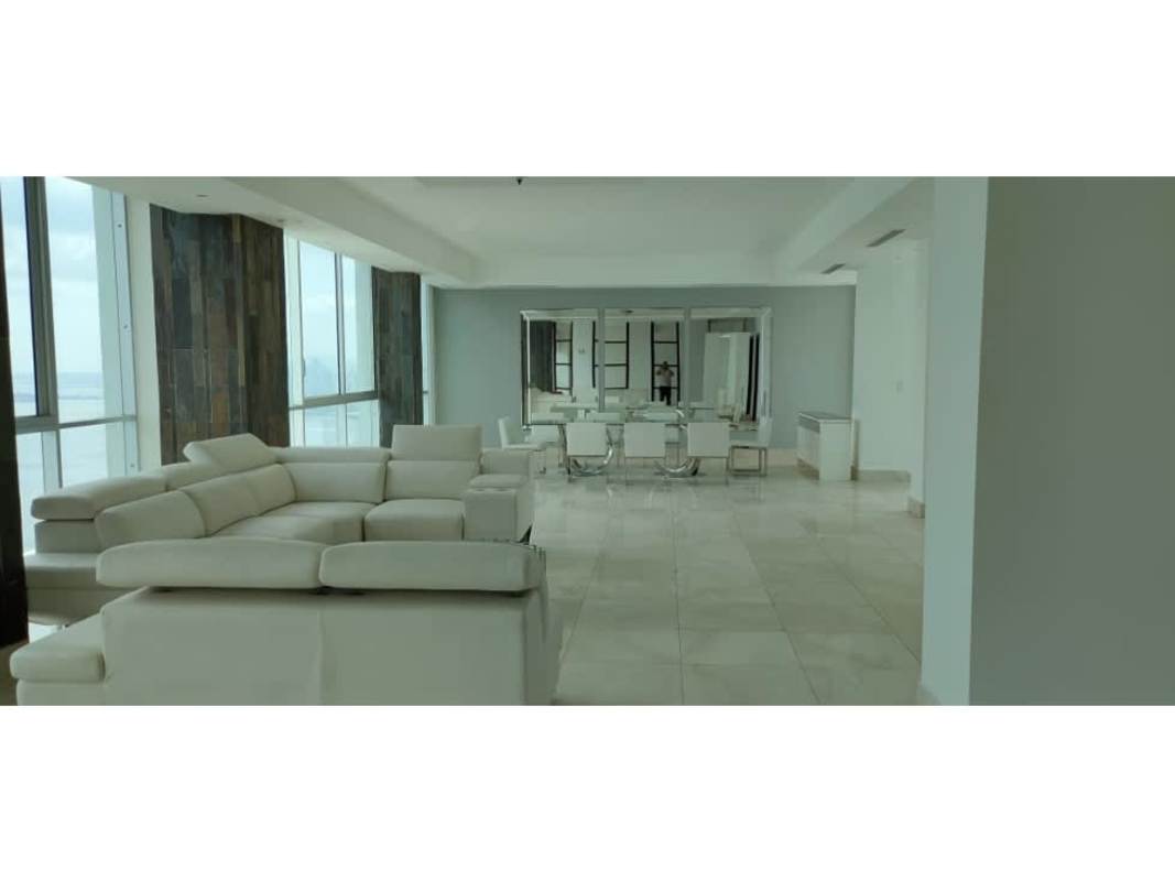 Modern open-plan living and dining area with large windows ocean view at Ocean Two Tower Panama