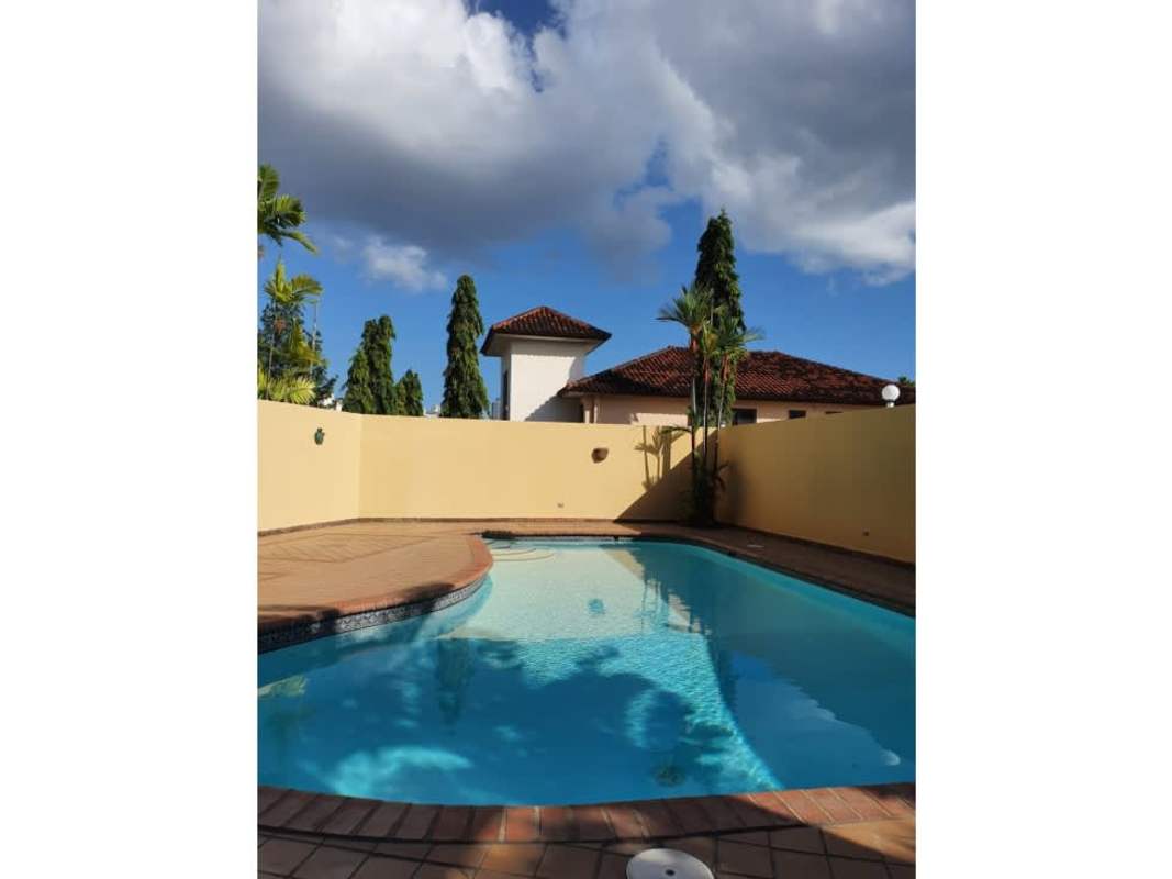 Private swimming pool with waterfall and large tiled terrace at Los Guayacanes Hato Pintado Panama
