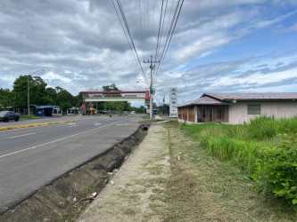 Commercial building with metal roof, large windows, situated roadside in Puerto Armuelles Chiriquí