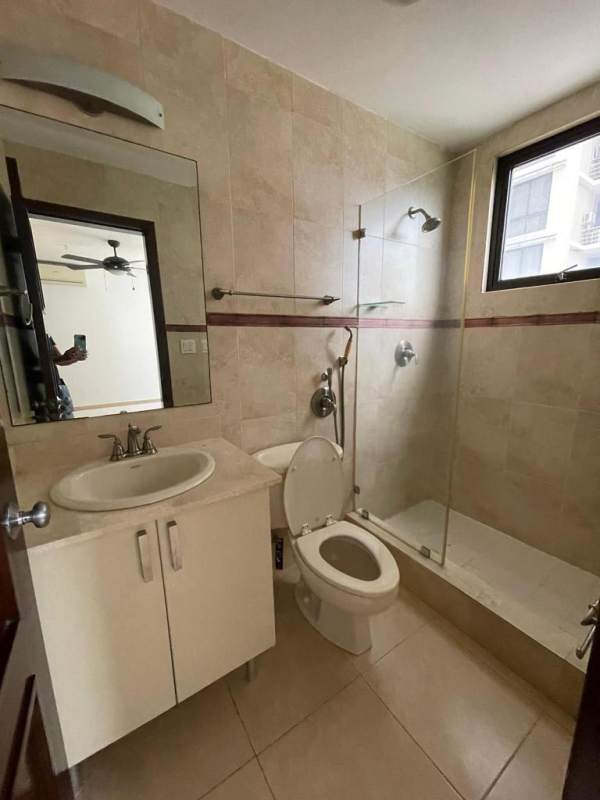 Modern bathroom with marble vanity and glass-enclosed shower at PH Parque del Mar Panama